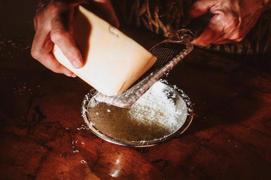 Grating Cocoa Butter Silk into a bowl