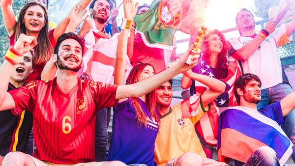 Fußball-Fans in Landesfarben mit Flaggen