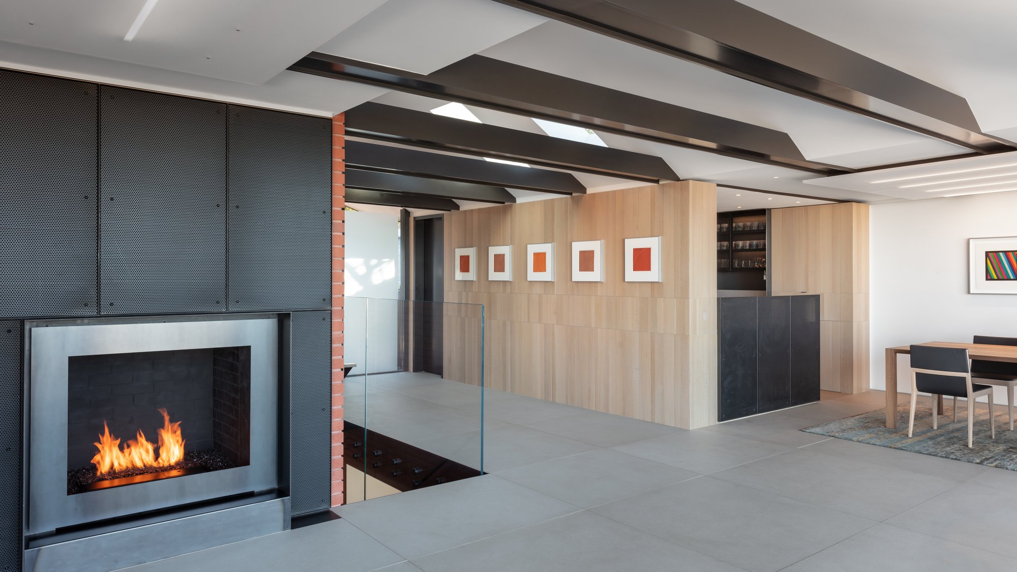 A modern, open-concept living space with warm wood tones, abundant natural light, and sleek, minimalist furnishings.