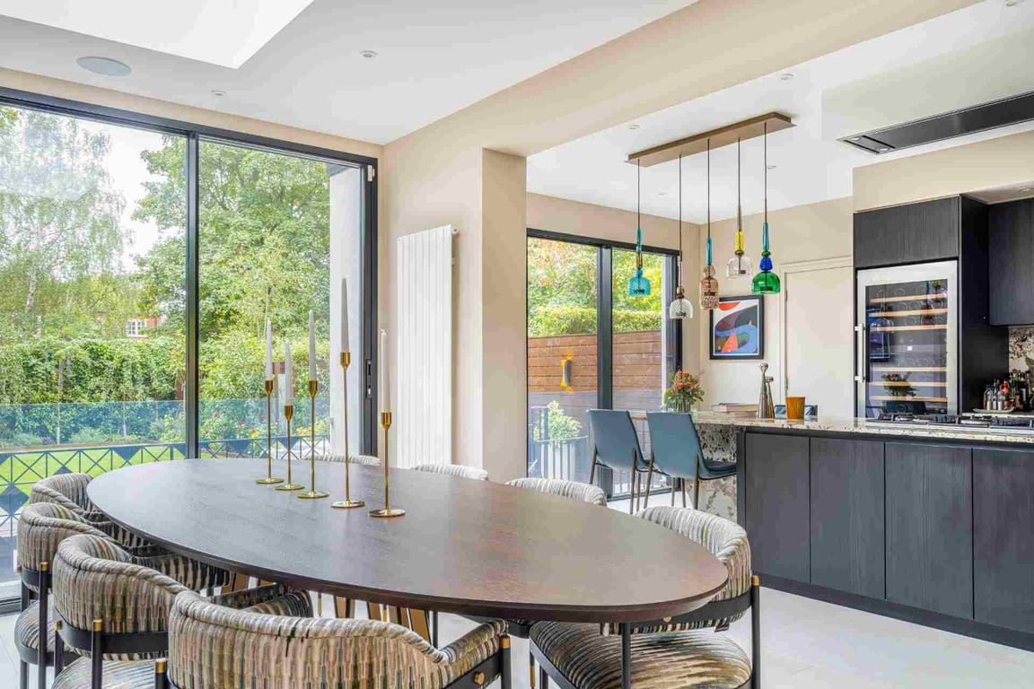 Modern kitchen with colourful pendant lights and a spacious dining table