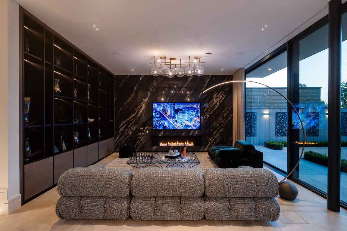 Cozy living room with dark marble feature wall and luxurious seating.