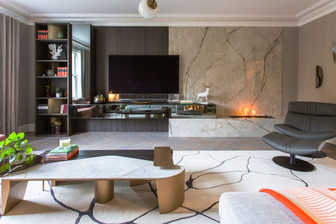 Contemporary living room with a marble feature wall, sleek TV unit, and modern fireplace.