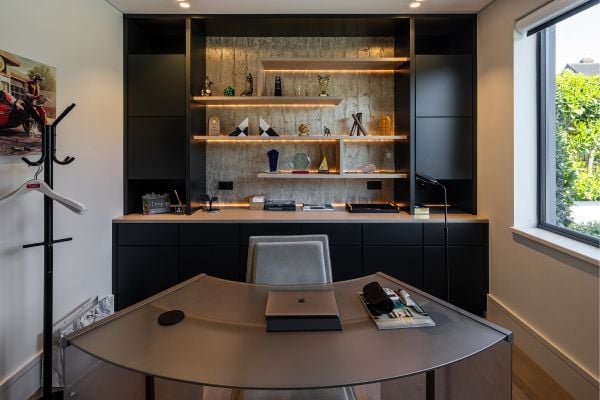 Sleek home office with black shelves and stylish decor accents.
