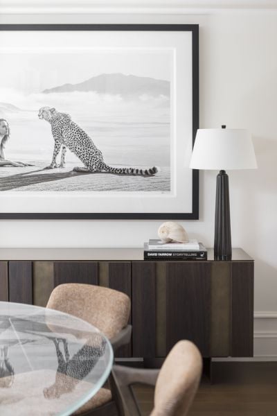 Close-up of a luxurious console table with abstract art in a modern dining room.