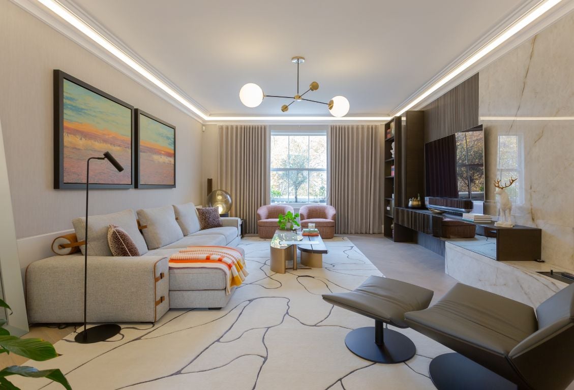 Contemporary living room in Holland Park with a minimalist sofa, artwork, and marble wall.