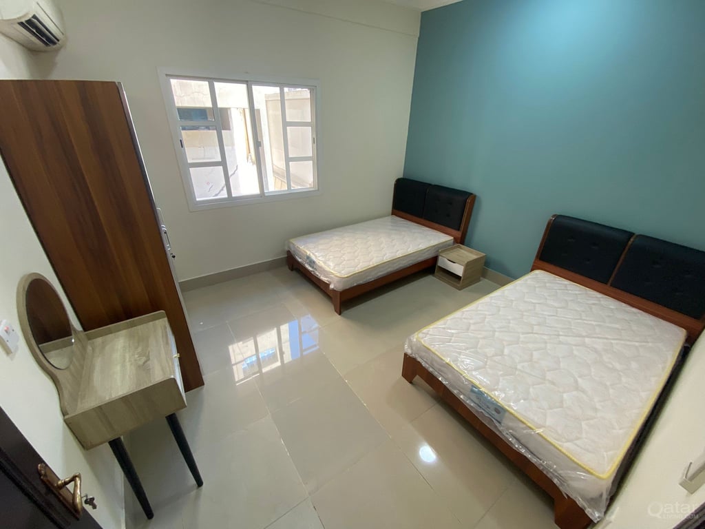 Semi furnished two bedroom building apartment for rent in al sadd