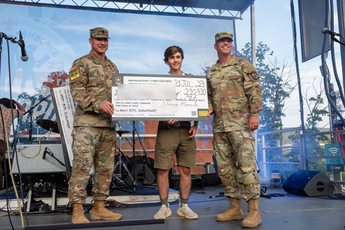 An Army Cadet Command general presents an Army ROTC scholarship to a high school student at a 2023 ceremony