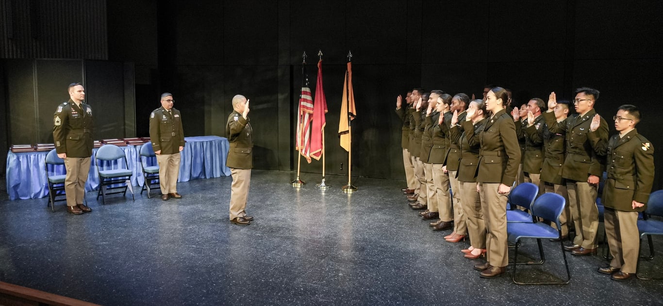 Newly commissioned Army officers stand in formation at an Army ROTC commissioning ceremony