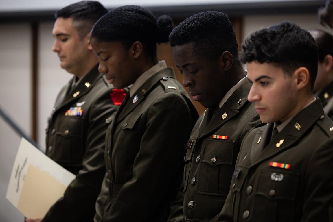 Army ROTC cadets take the oath of office at a commissioning ceremony