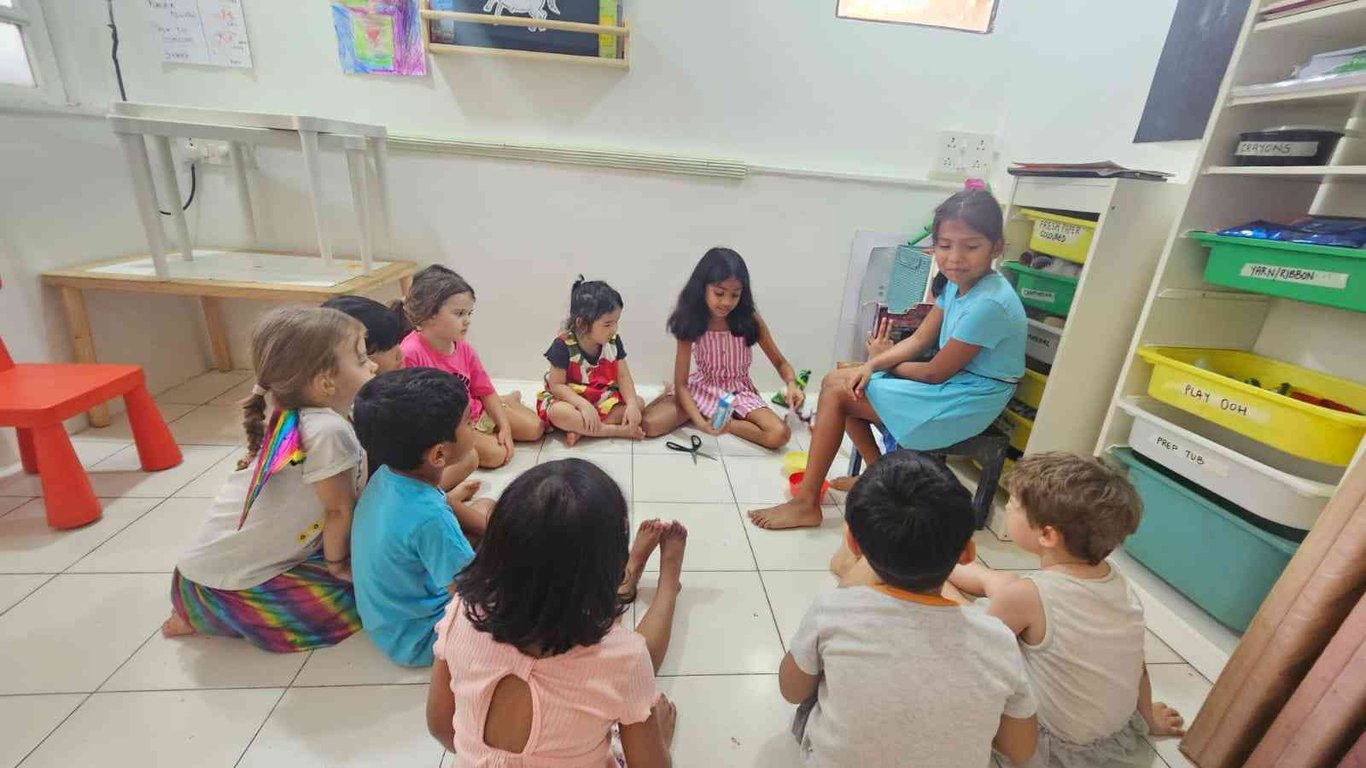 7 year old N and 9 year old M conducting a craft class for 3-5 year olds