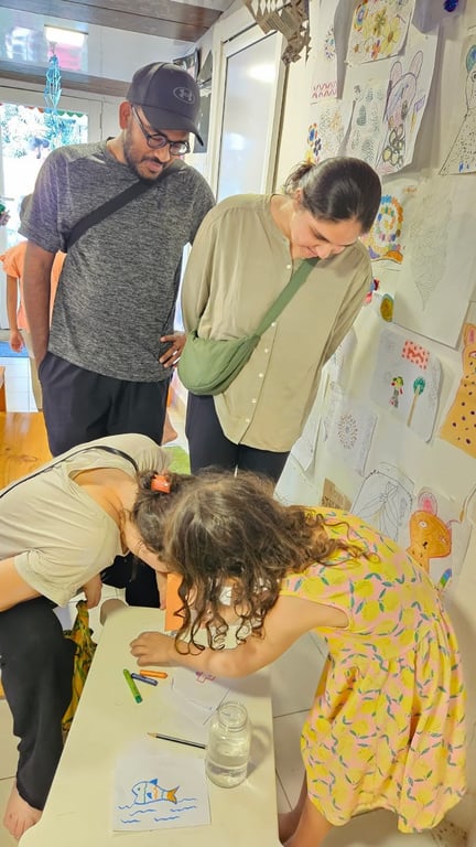 Parents checking out a science demonstration about light hosted by the kids