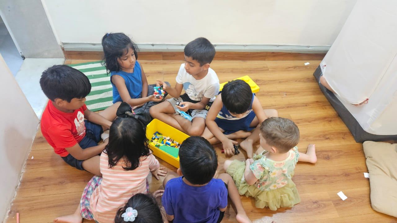 Eight year old A and six year old K doing a "lego class" for their 3-5 year old friends