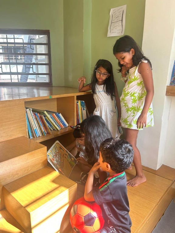 Nine-year old M reads to the group in the library while waiting for pickup