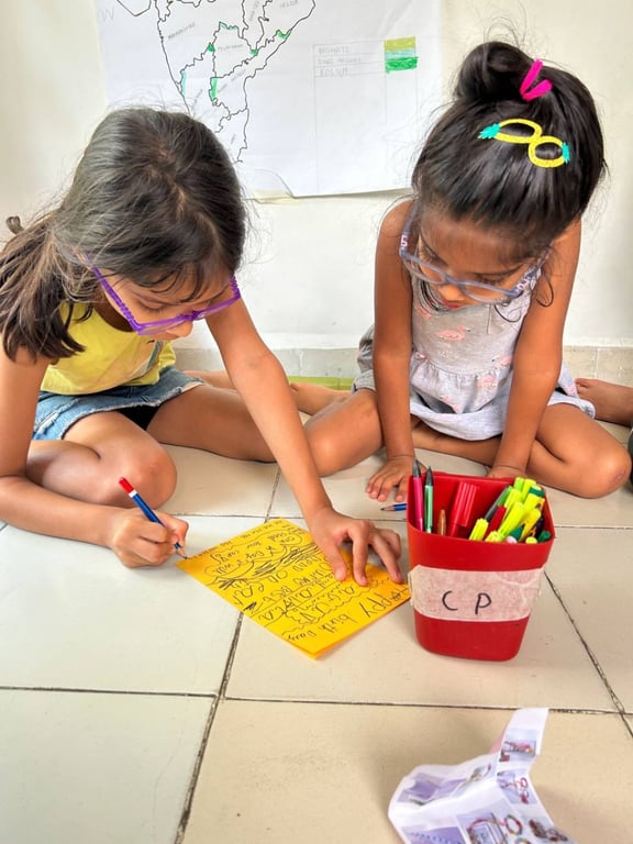 Eight year old M and six year old A make a joint birthday card for their friend