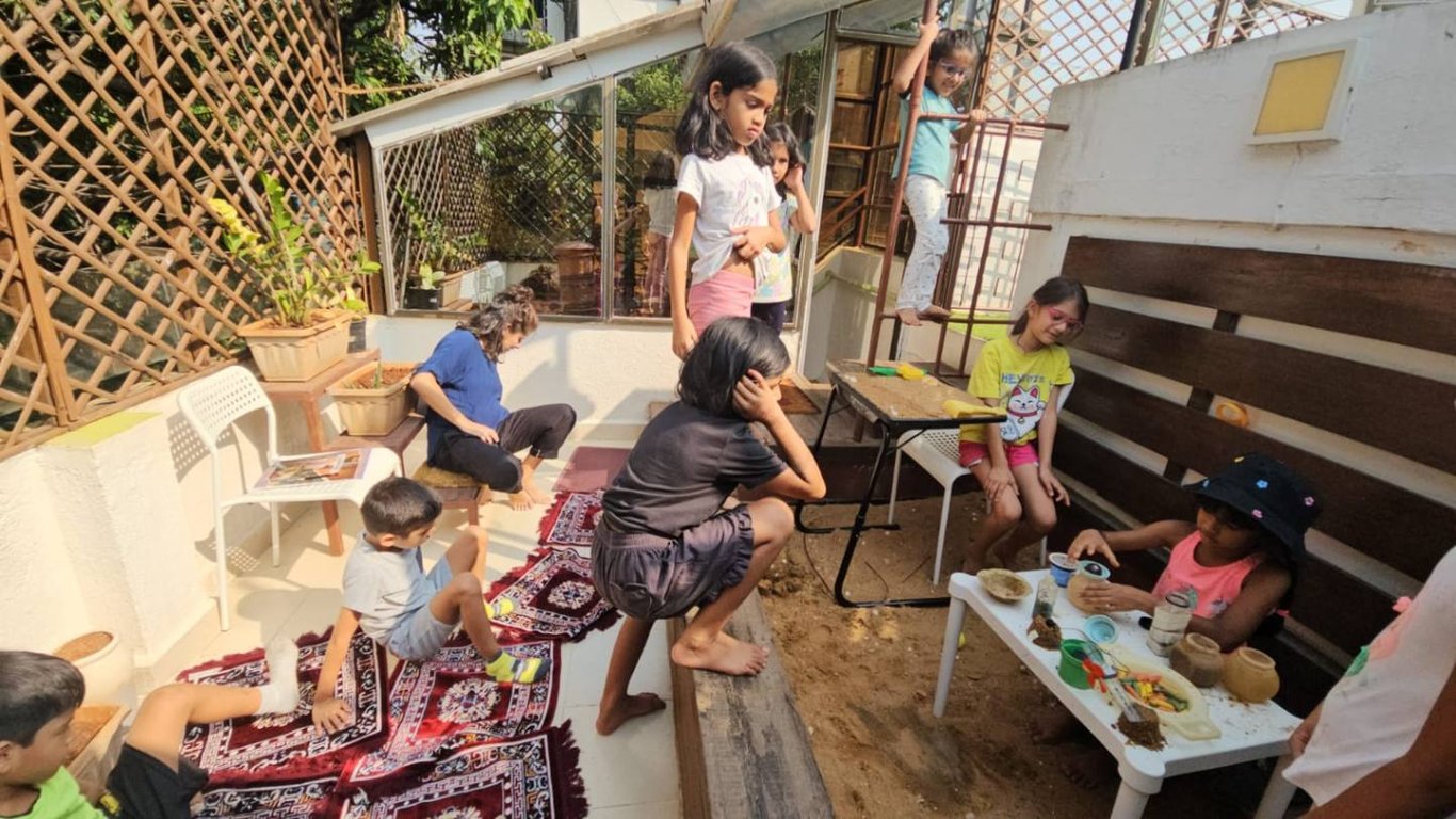 Silently watching the kids create an elaborate sand-play set up. At the cost of an intensive clean up