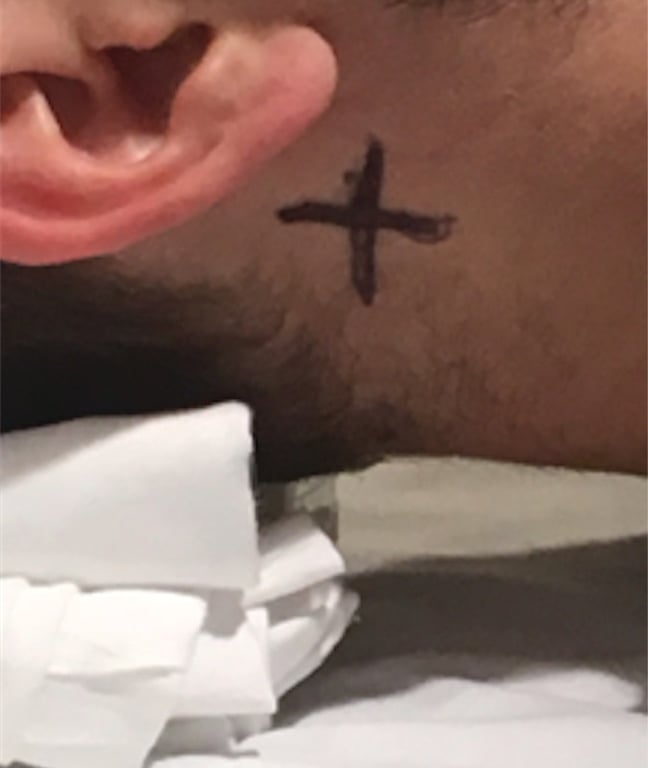 A person's arm with a cross on it AI-generated content may be incorrect.
