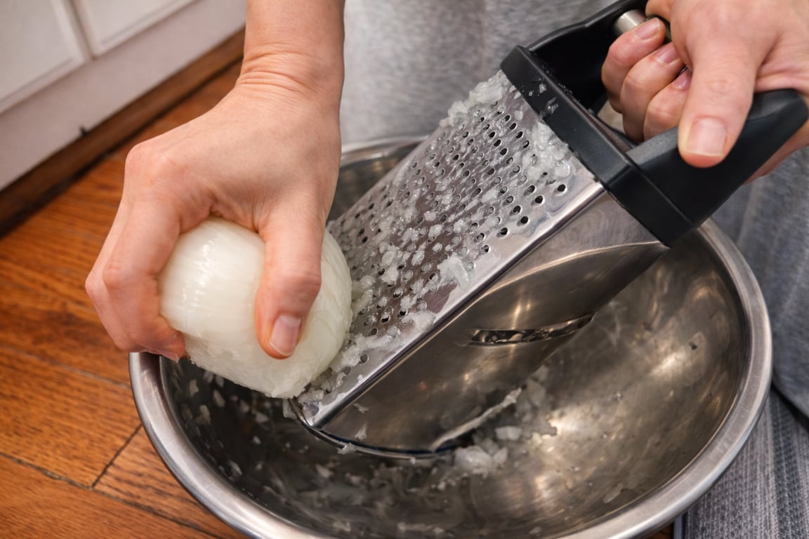Grate the onion instead of chopping it. The pulp melts into the meatballs, adding moisture and sweetness without any harsh onion bite.