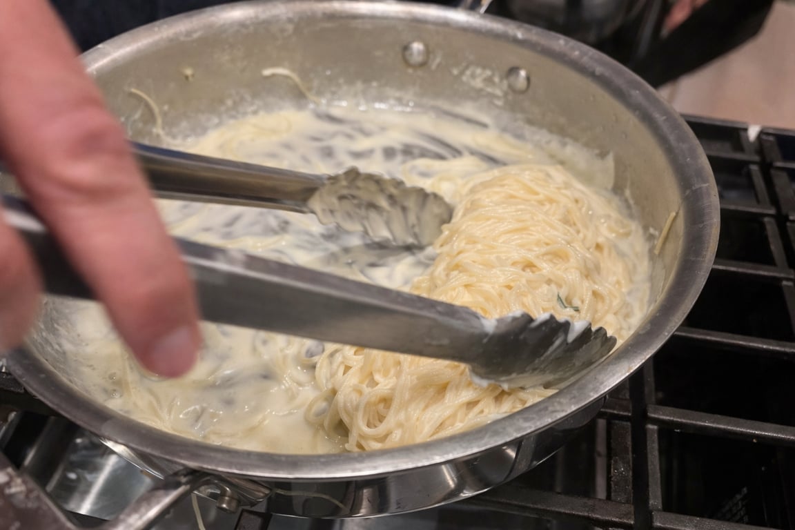 The pasta should be glossy and lightly coated—not swimming, not tight.