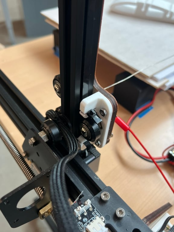 Slotted mount attaches belts to vertical axis plate