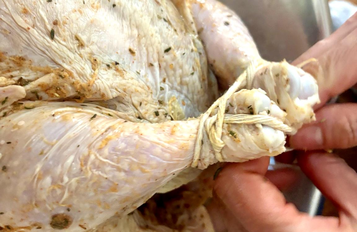 Trussing promotes even cooking and helps the chicken hold its shape.