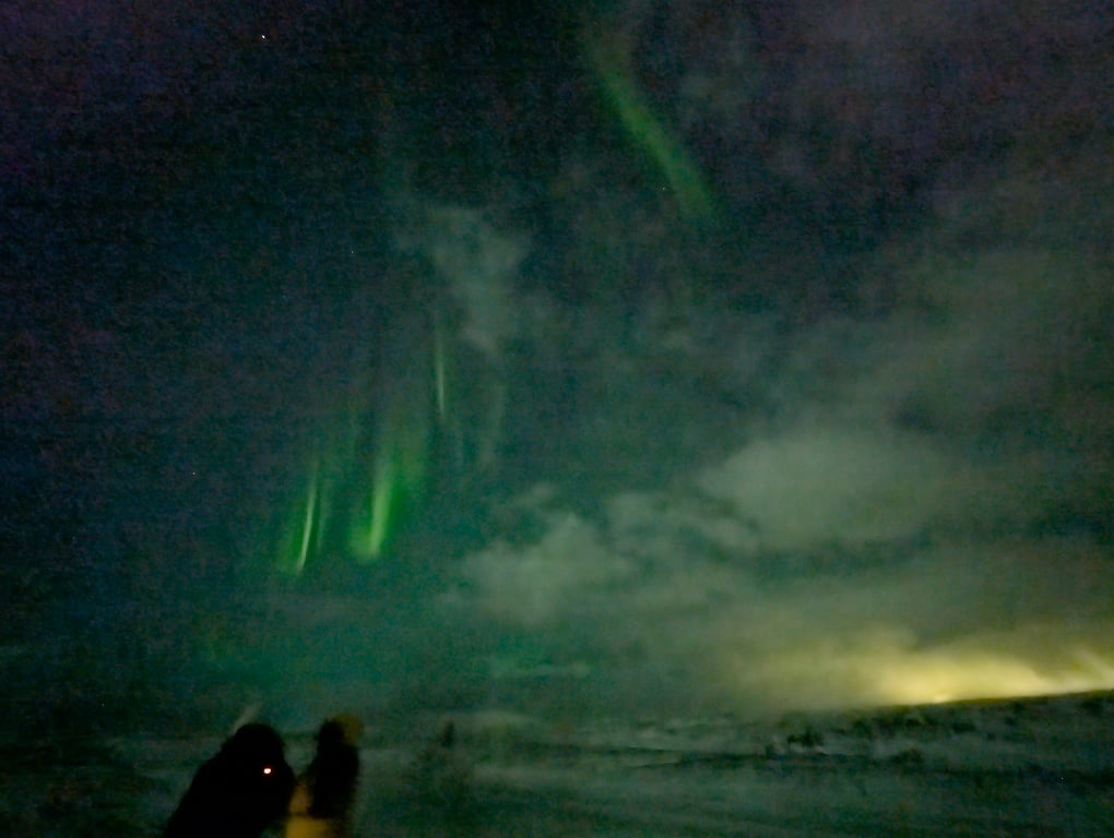 Iceland green Northern Lights with an overcast sky.