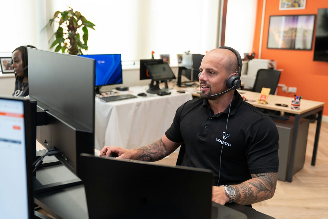 Photo by Vagaro on Unsplash — call center agent with headset, representing AI-powered call review automation