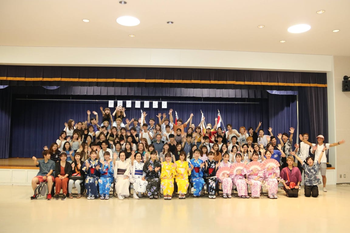 Group photo. See the black shirt guy whoโs two rows behind the 2 yellow kimono girls? Iโm to the left of him.