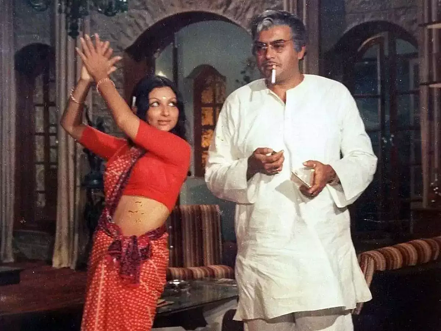 sanjeev kumar smoking and sharmila tagore dancing beside him in a still from the movie mausum