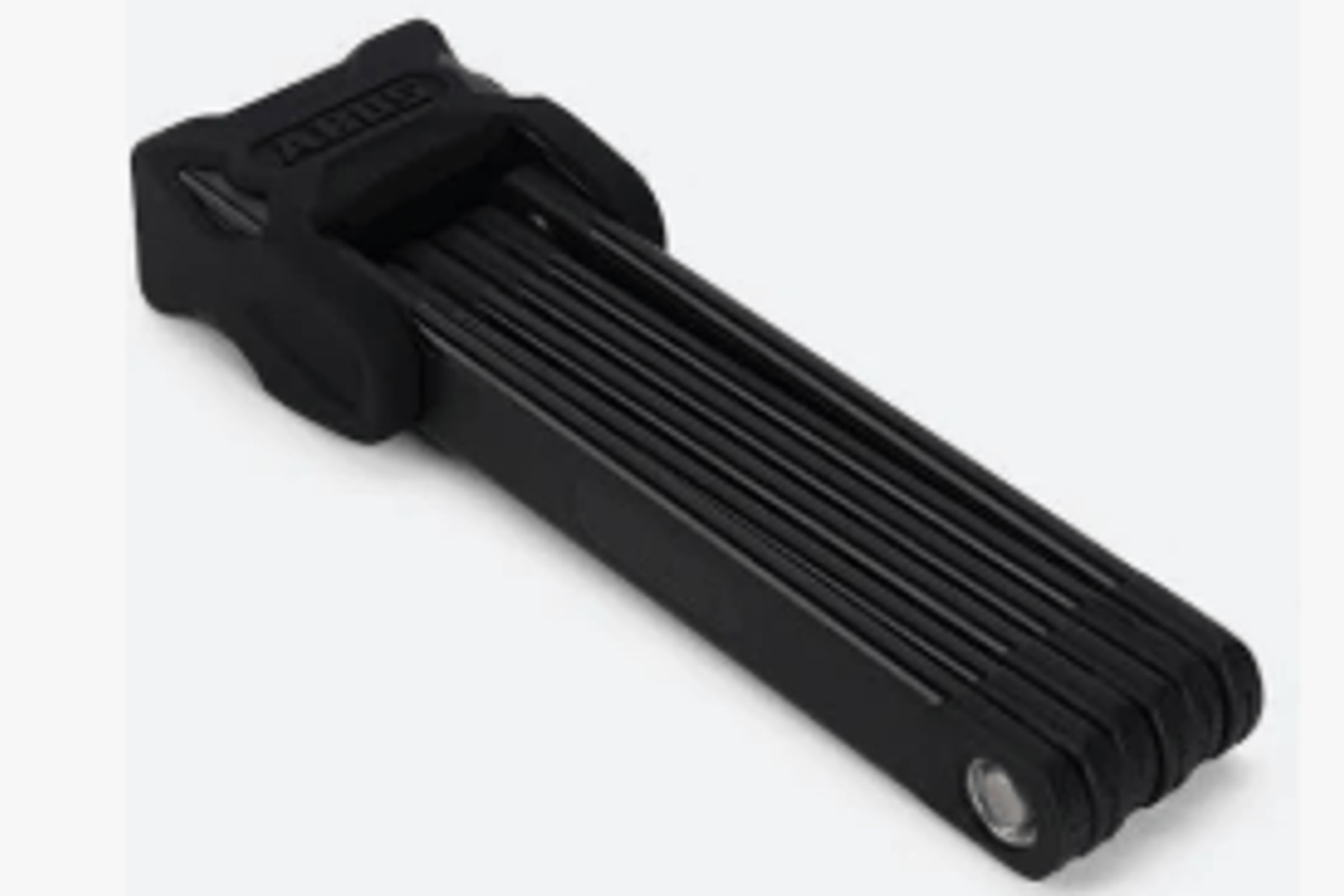 Svart Abus foldelås liggende på underlag.