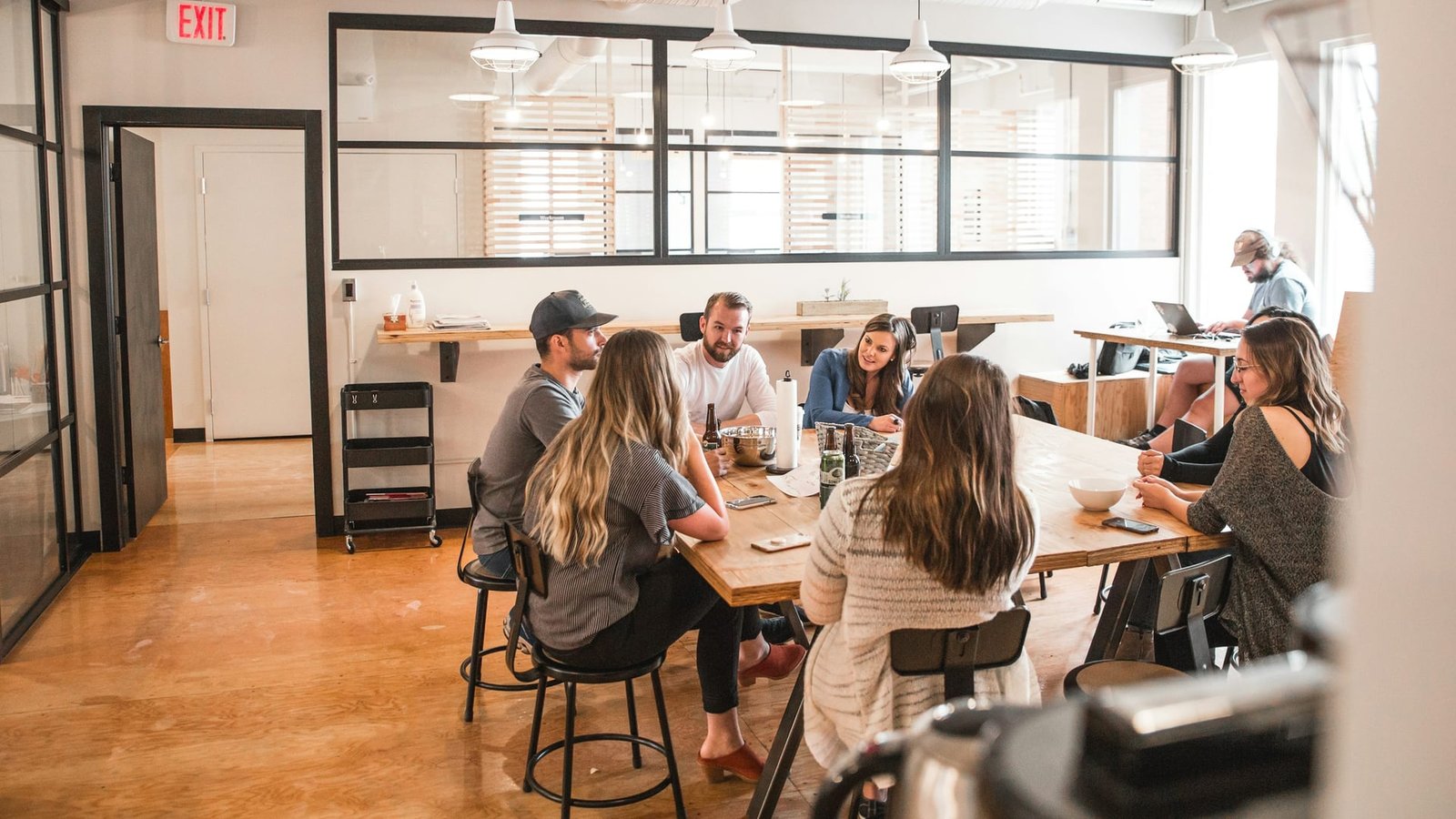 Team members communicating and discussing operational processes around a table
