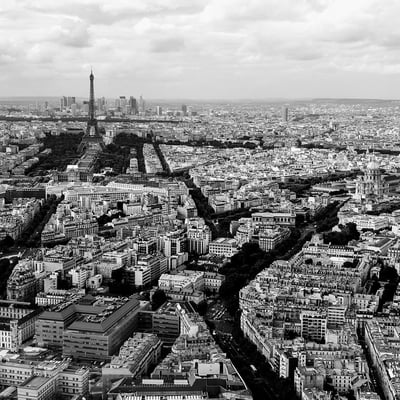 Black and white view of the Eiffel Tower with surrounding Paris cityscape