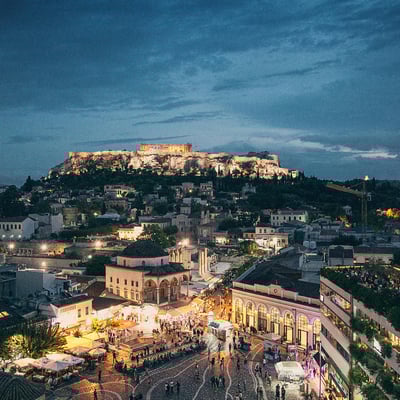 Evening view over Athens with the Acropolis lit against the twilight sky