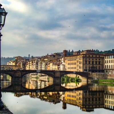 The Arno River flowing under historic bridges in Florence