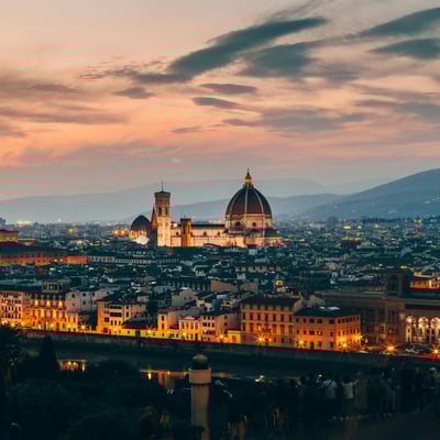 Florence’s Duomo glowing warmly at dusk above the city’s historic skyline