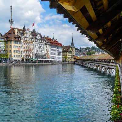 Scenic view of Lucerne’s historic old town as seen from Chapel Bridge at river’s edge