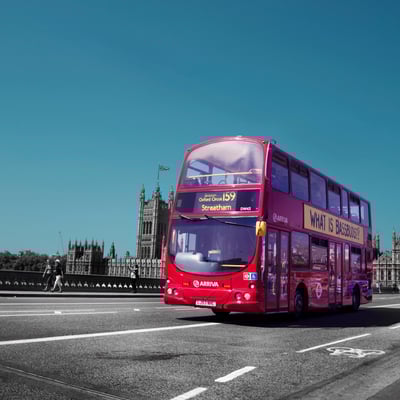 Classic red double-decker bus driving through London