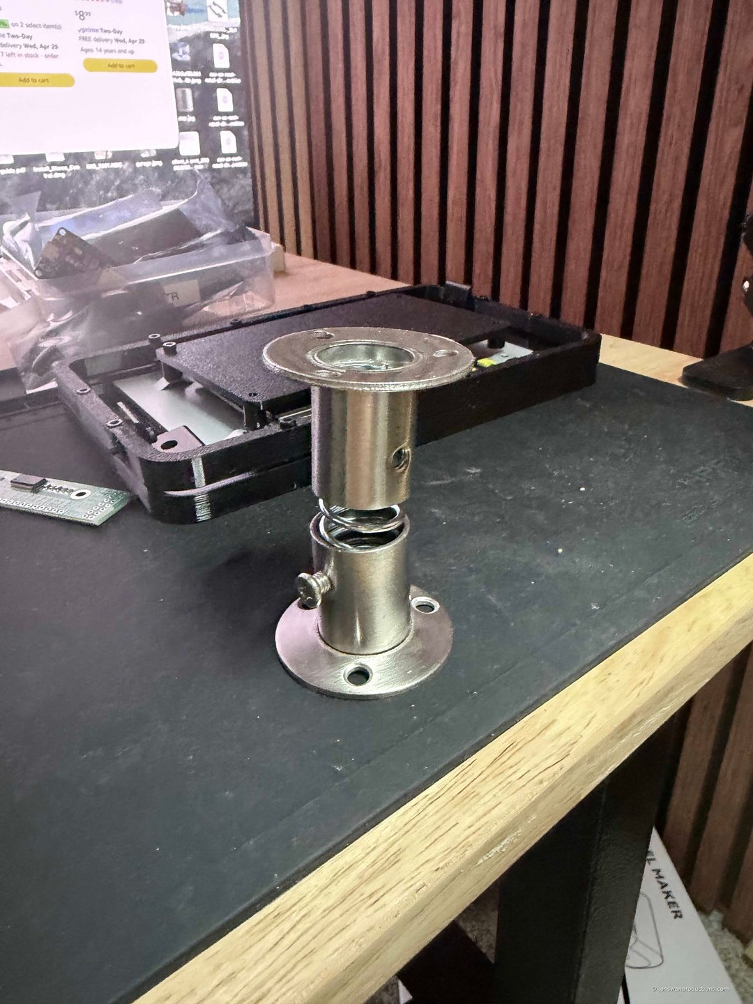 Closet rod bracket shock absorber assembly with spring and rubber plug