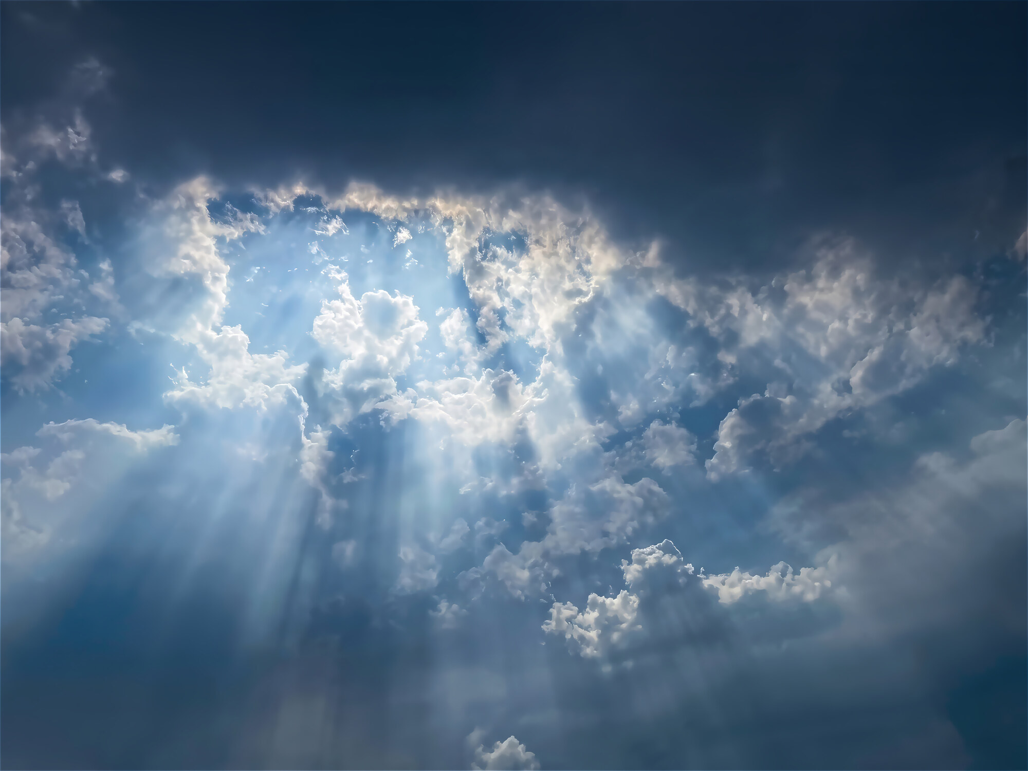 Sunbeams breaking through storm clouds over Oregon's Willamette Valley