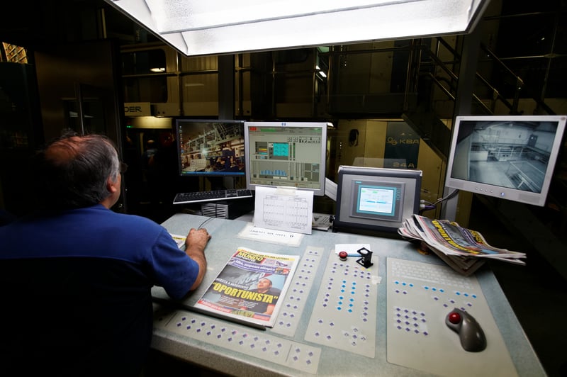 Machine operator at press control panel