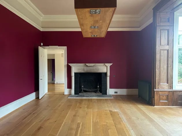 Empty panelled room with red walls