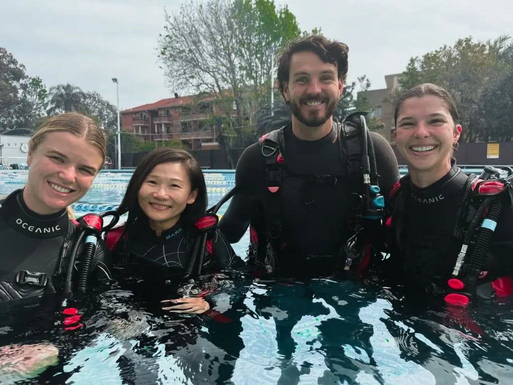 Student practising scuba skills in a pool with an instructor