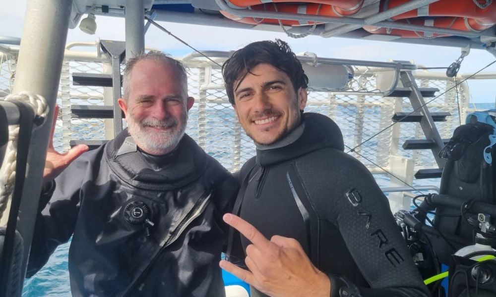 A friendly interaction among divers on a dive boat, showcasing kindness and camaraderie.