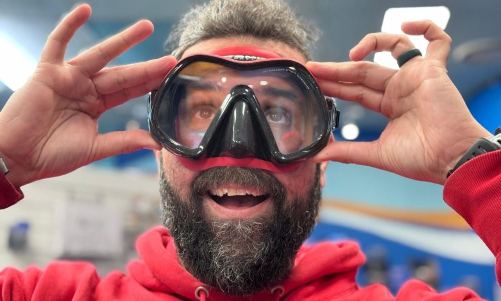 Various recommended dive masks for facial hair users displayed in a dive shop.