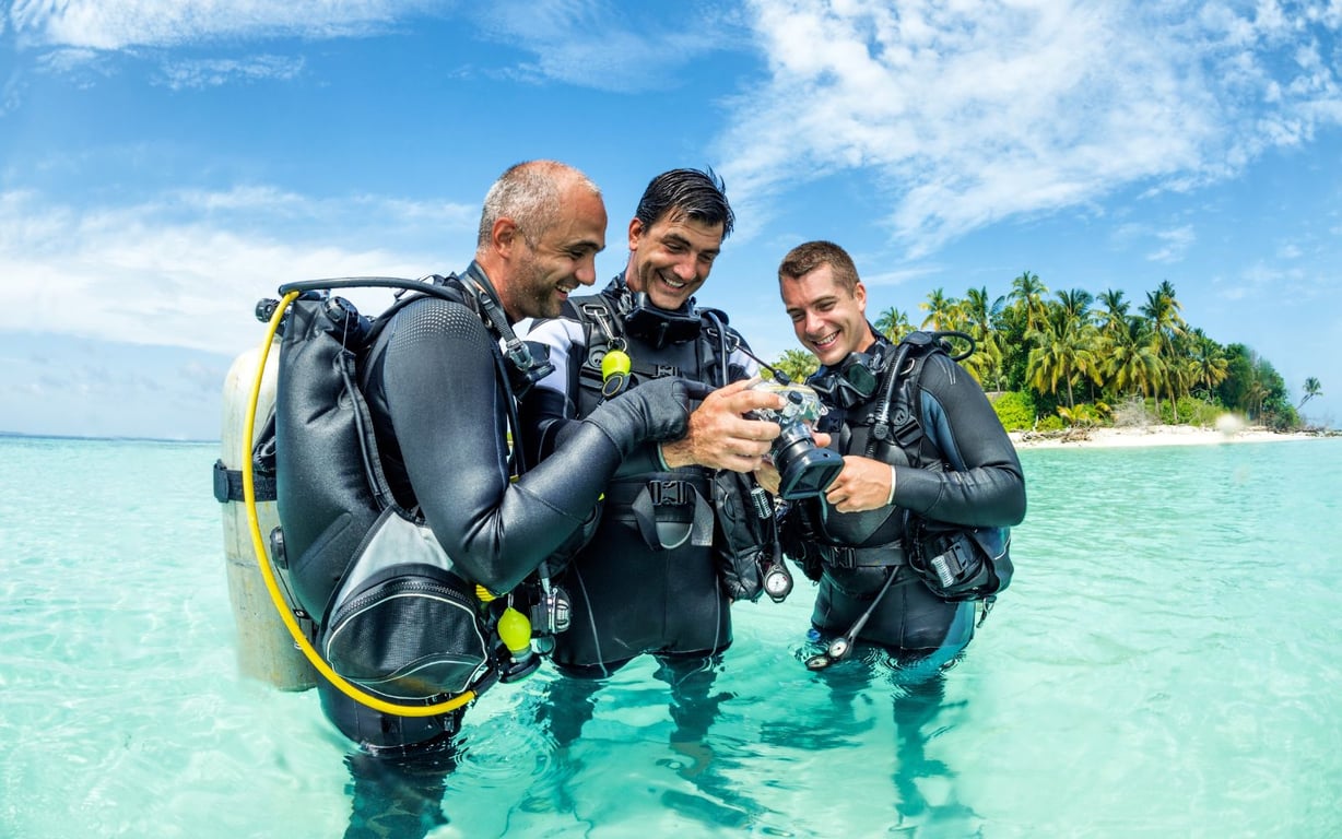 Divers happily reviewing photographs after a relaxed overseas reef dive