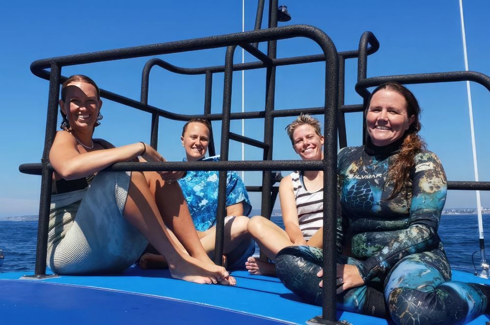 Freedivers enjoying the sun while taking a break between dives on the Abyss dive boat