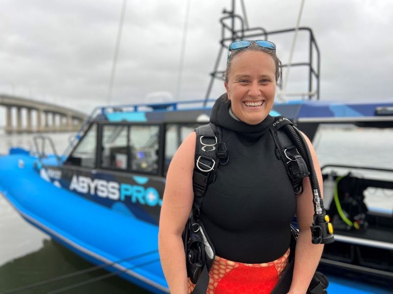 Safety protocols being discussed for shark diving, highlighting the importance of preparation and awareness.