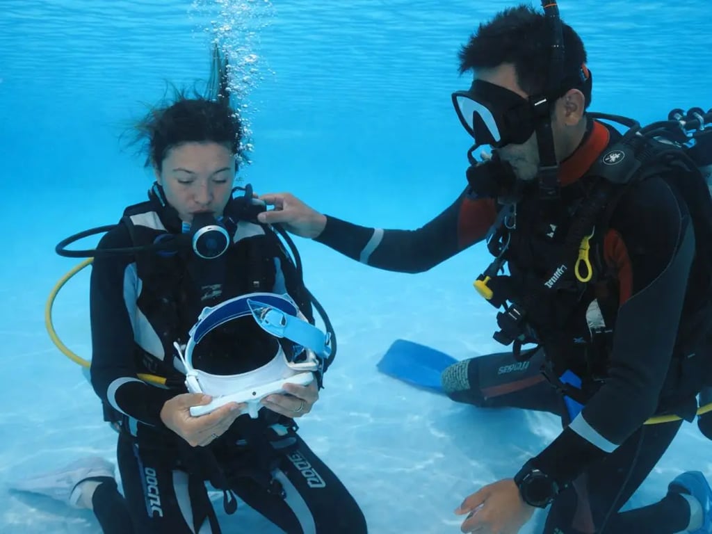 Friendly dive instructors assisting students in the pool