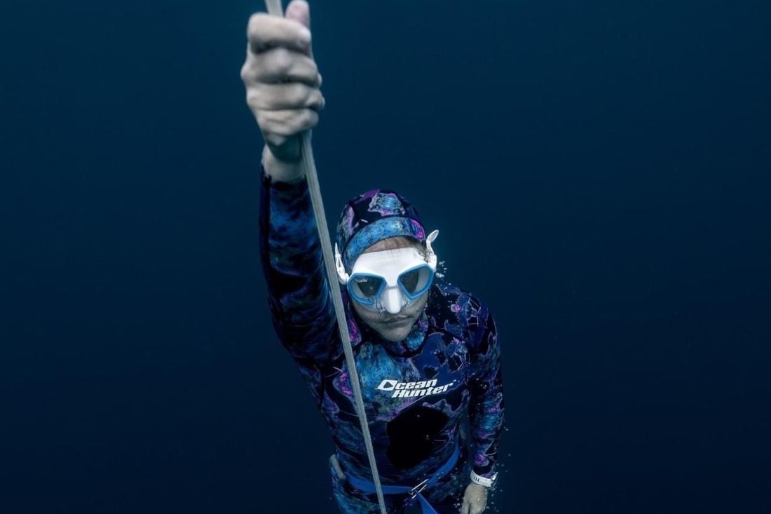 Freediver returning to the surface after a successful dive