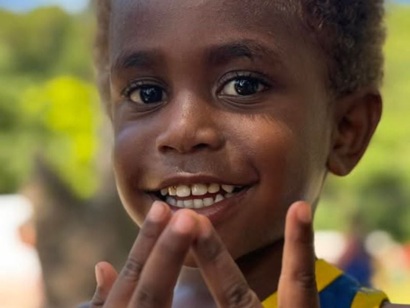 Smiling child in Vanuatu during a community visit