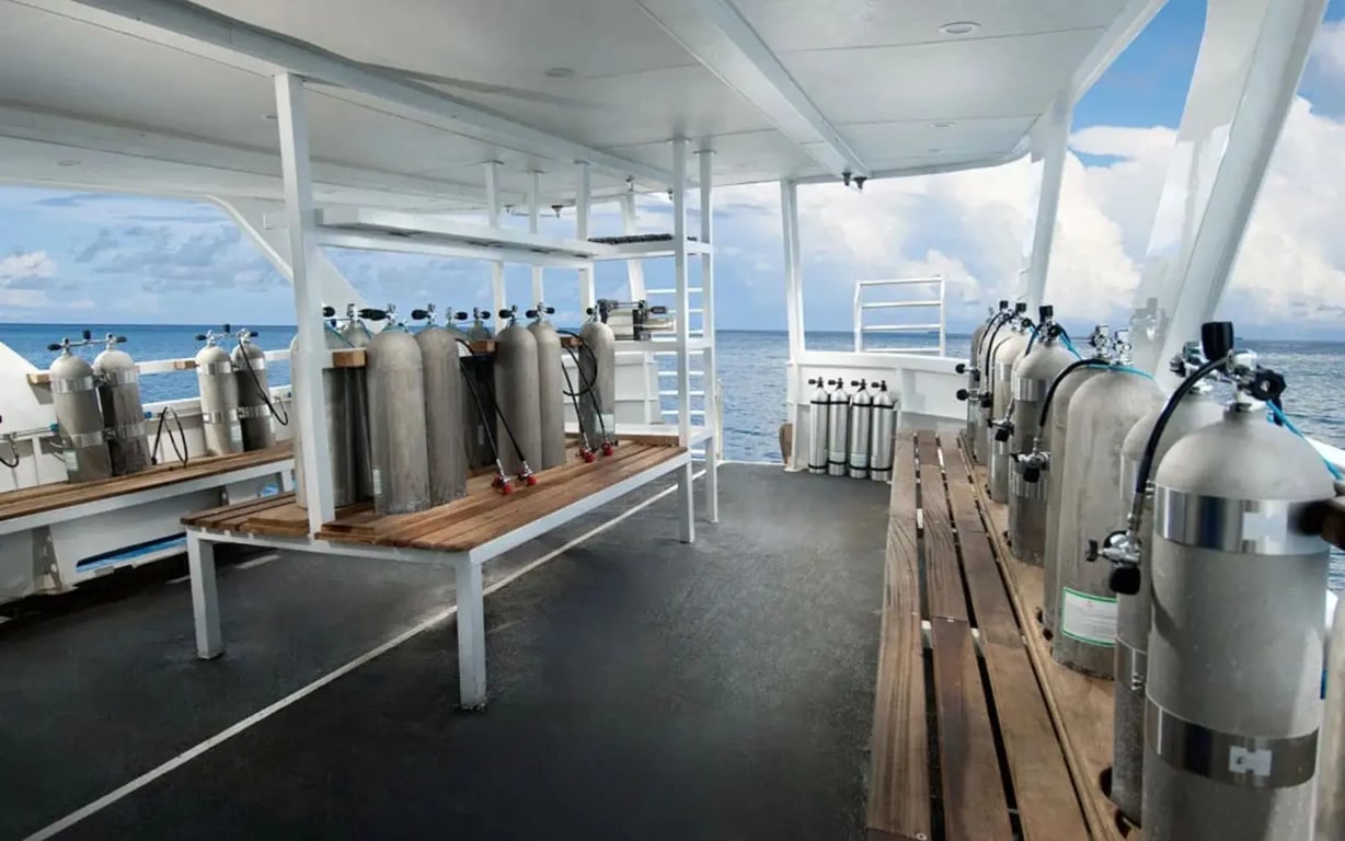 Liveaboard back deck with scuba tanks and dive gear ready for the next dive